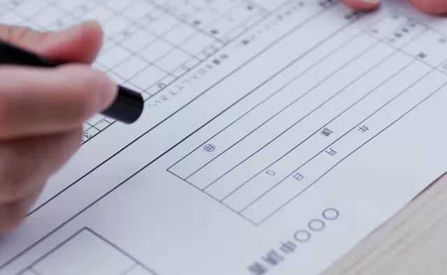 葬儀後に行う書類を書いている様子。
